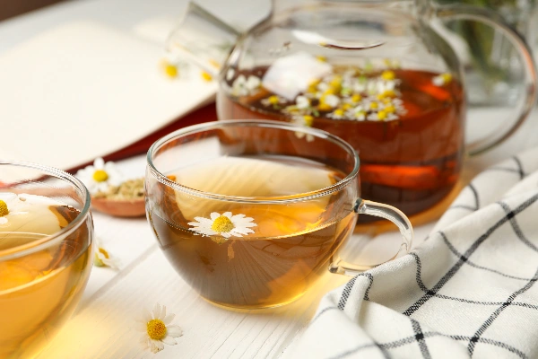 chamomile tea on white wooden table