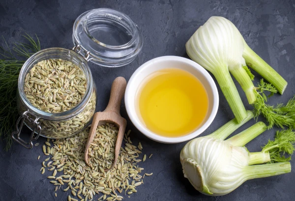 fennel seeds next to cup of fennel tea