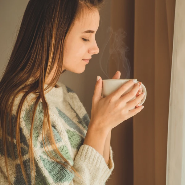 woman enjoying steeped green tea at home